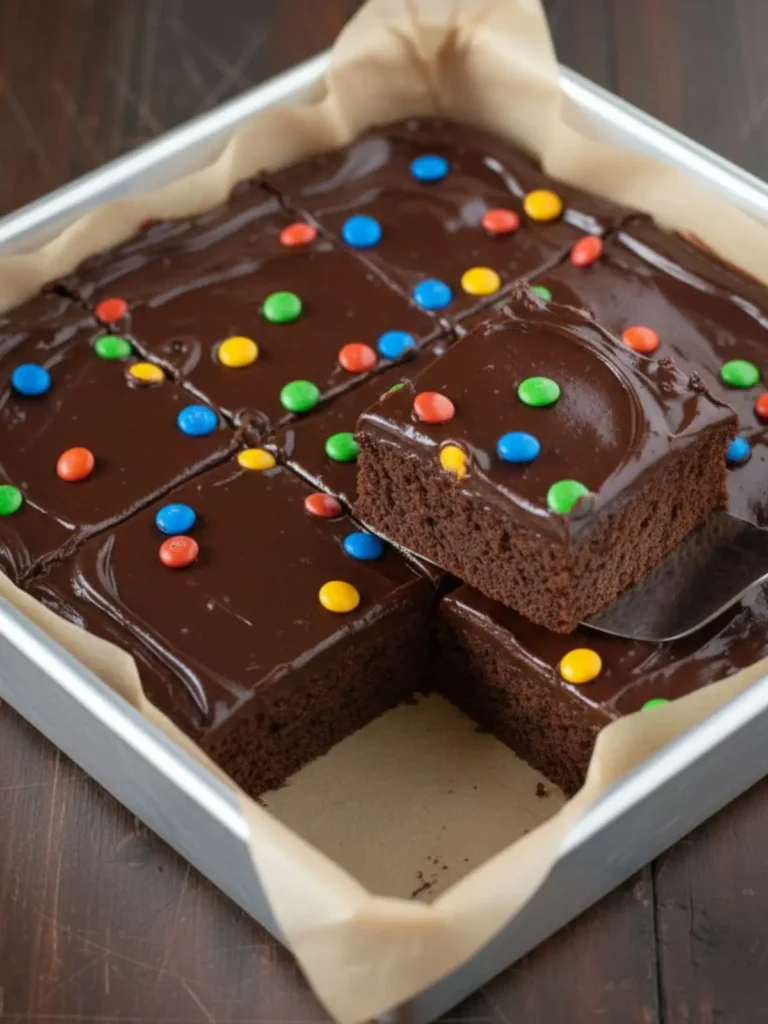 Cosmic Brownies Recipe Close-up plated serving of cosmic brownies with fudgy chewy texture, glossy chocolate topping, and rainbow candy chips in sharp detail.